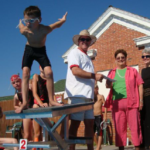 Member of the Fort Scott Hurricanes swim team prepares to jump off a diving board