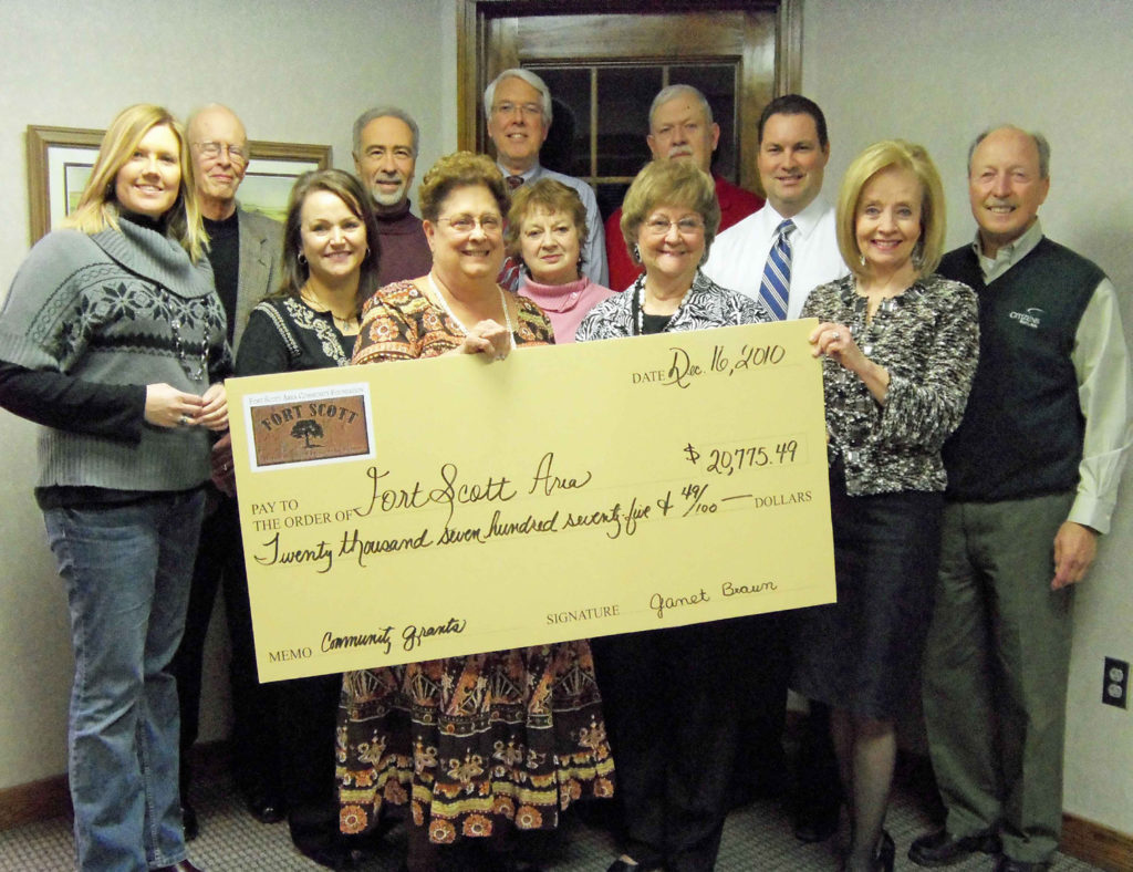 Members of the FSACF Board of Directors pose with an oversized check.
