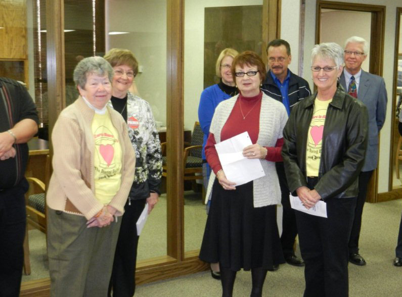 Members of the FSACF board pose with representatives of Care to Share.