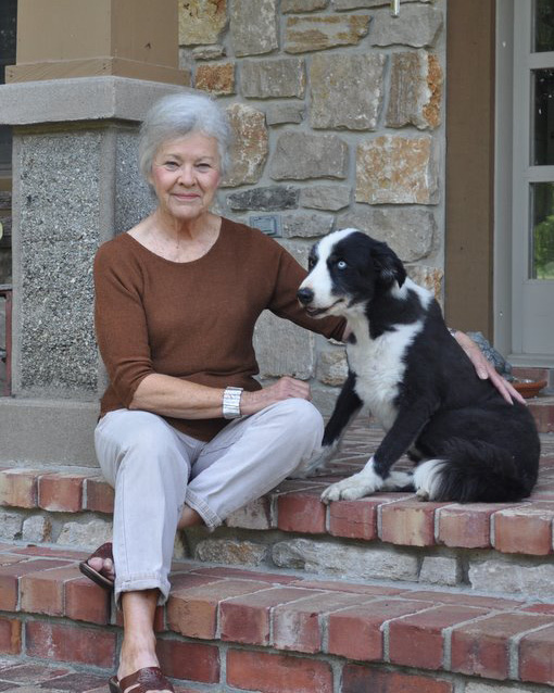 Portrait of Judy Marshall and her dog Jake.