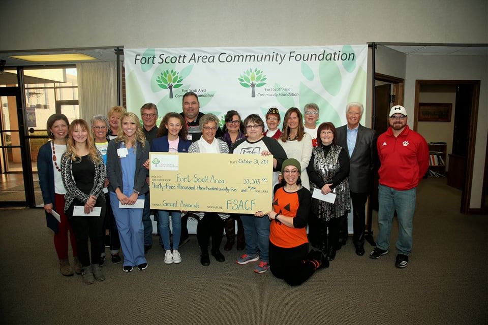 FSACF 2019 grant recipients pose with an oversized check.