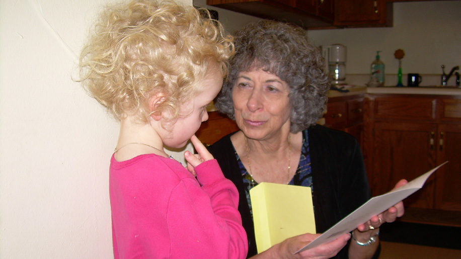 Wilma Leach of Mother to Mother Ministry of Bourbon County reading to a child.